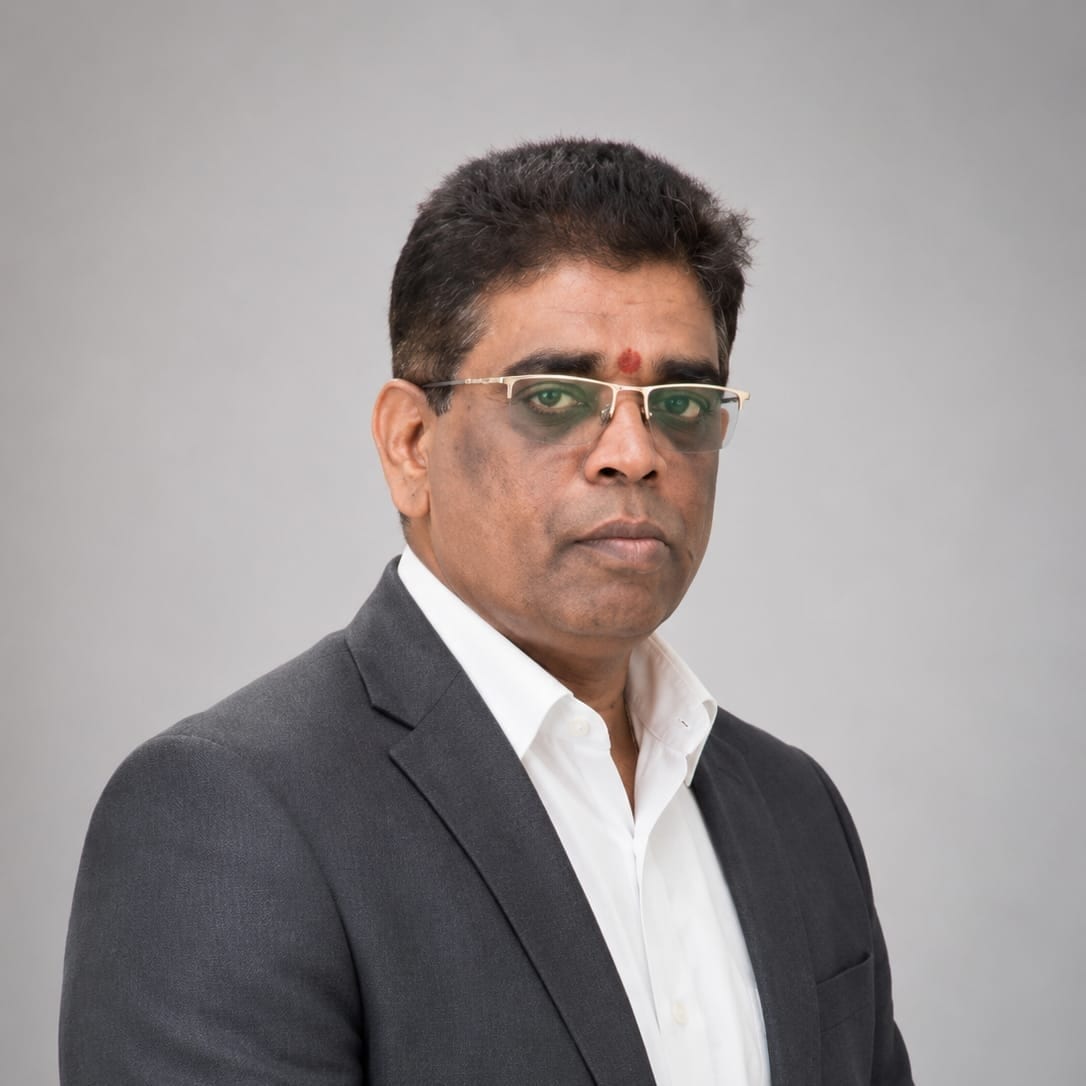 Portrait of Senthil Kumar, Chairman & Founder of United Enterprises, wearing a dark suit
